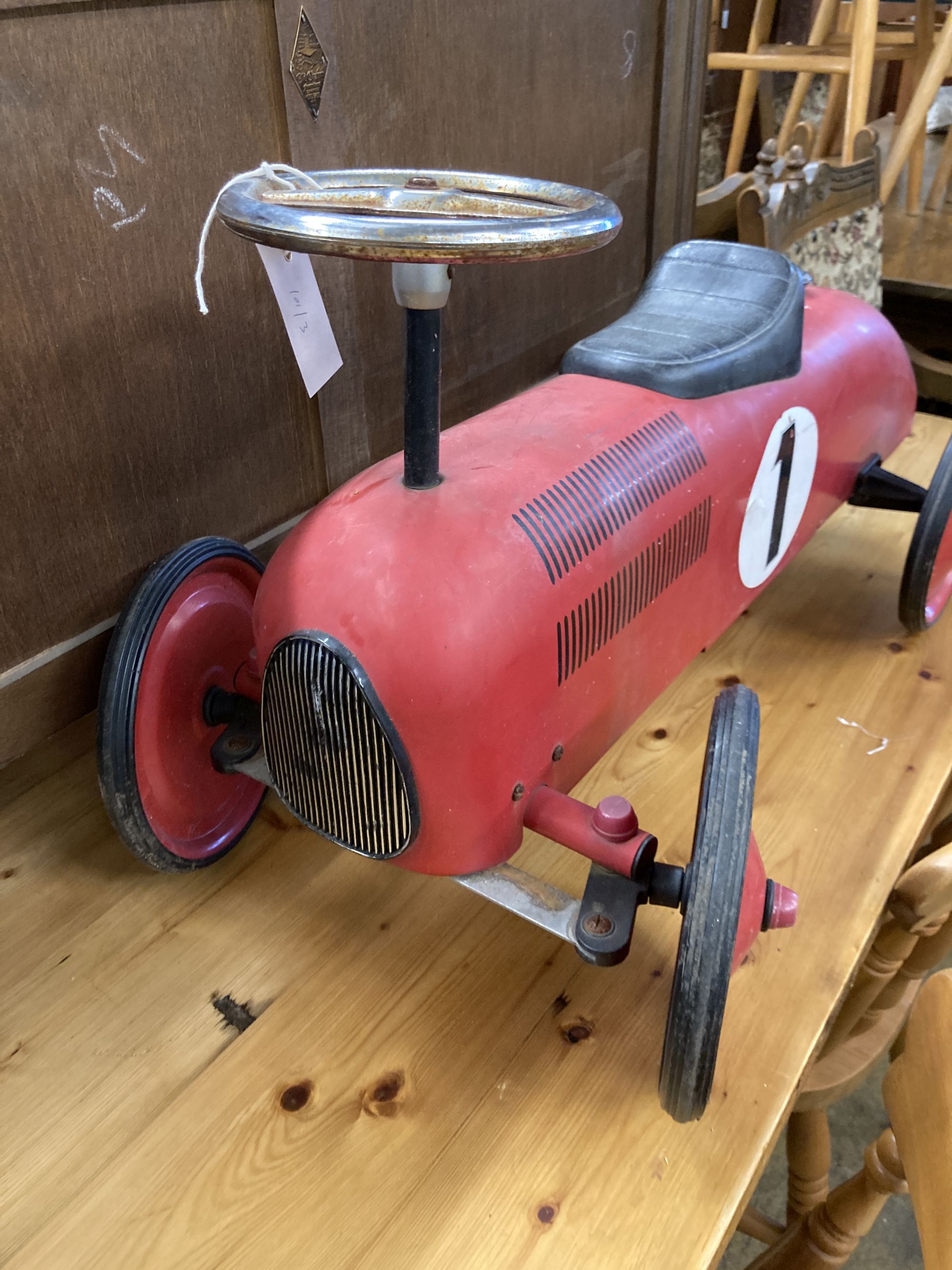 A child's vintage style painted metal sit on toy racing car, length 76cm